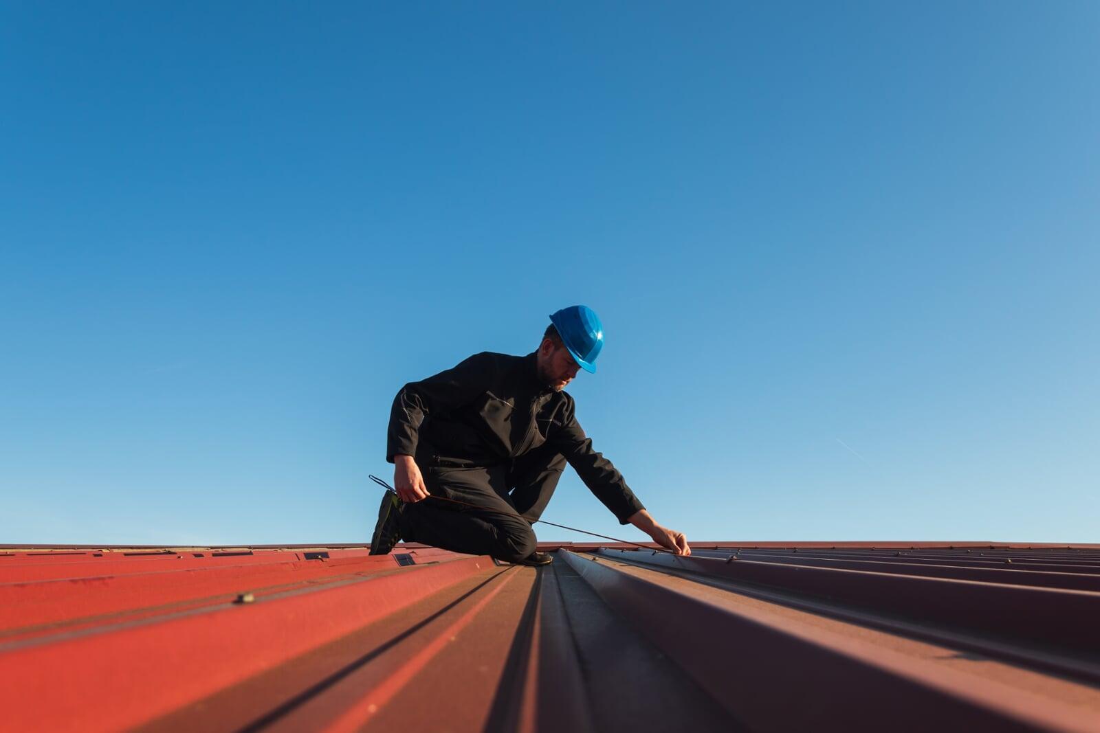 Technician measuring metal roof in Florida